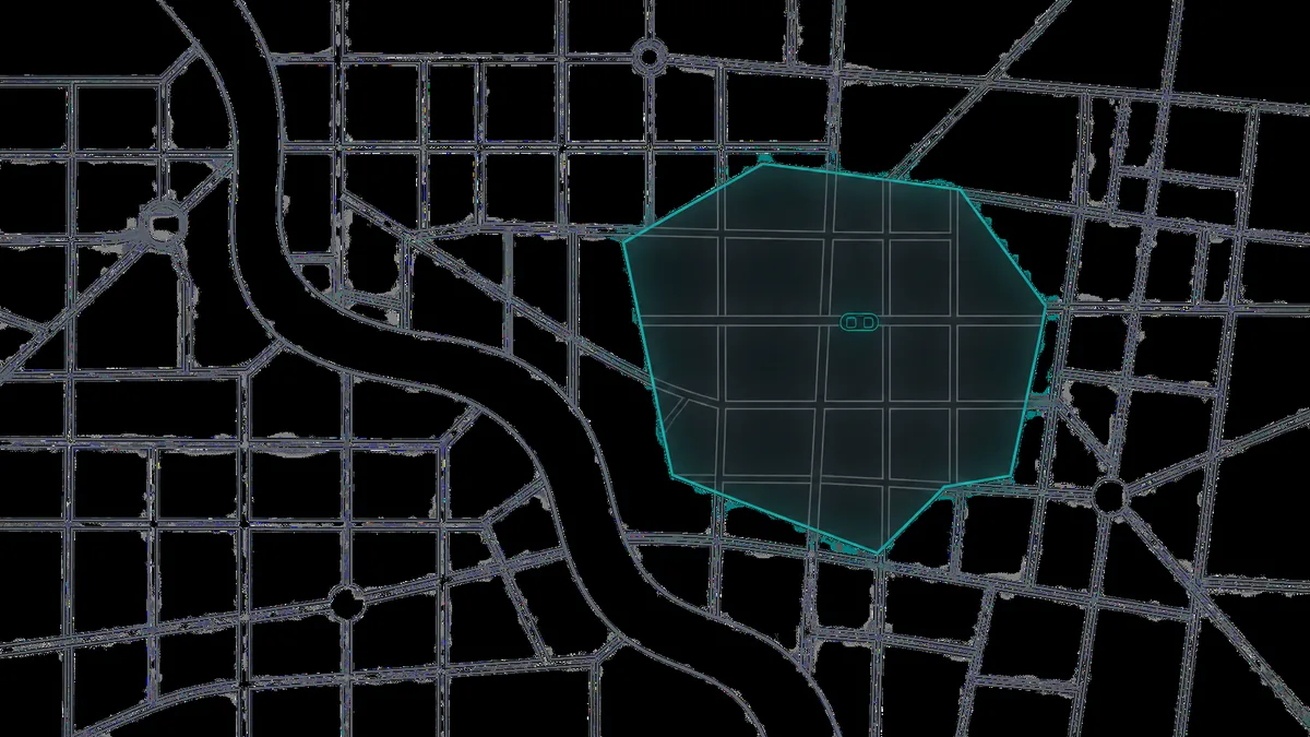 A thin boundary drawn around one part of a simplified street map, with a single small two-seat vehicle inside it and the streets outside empty.